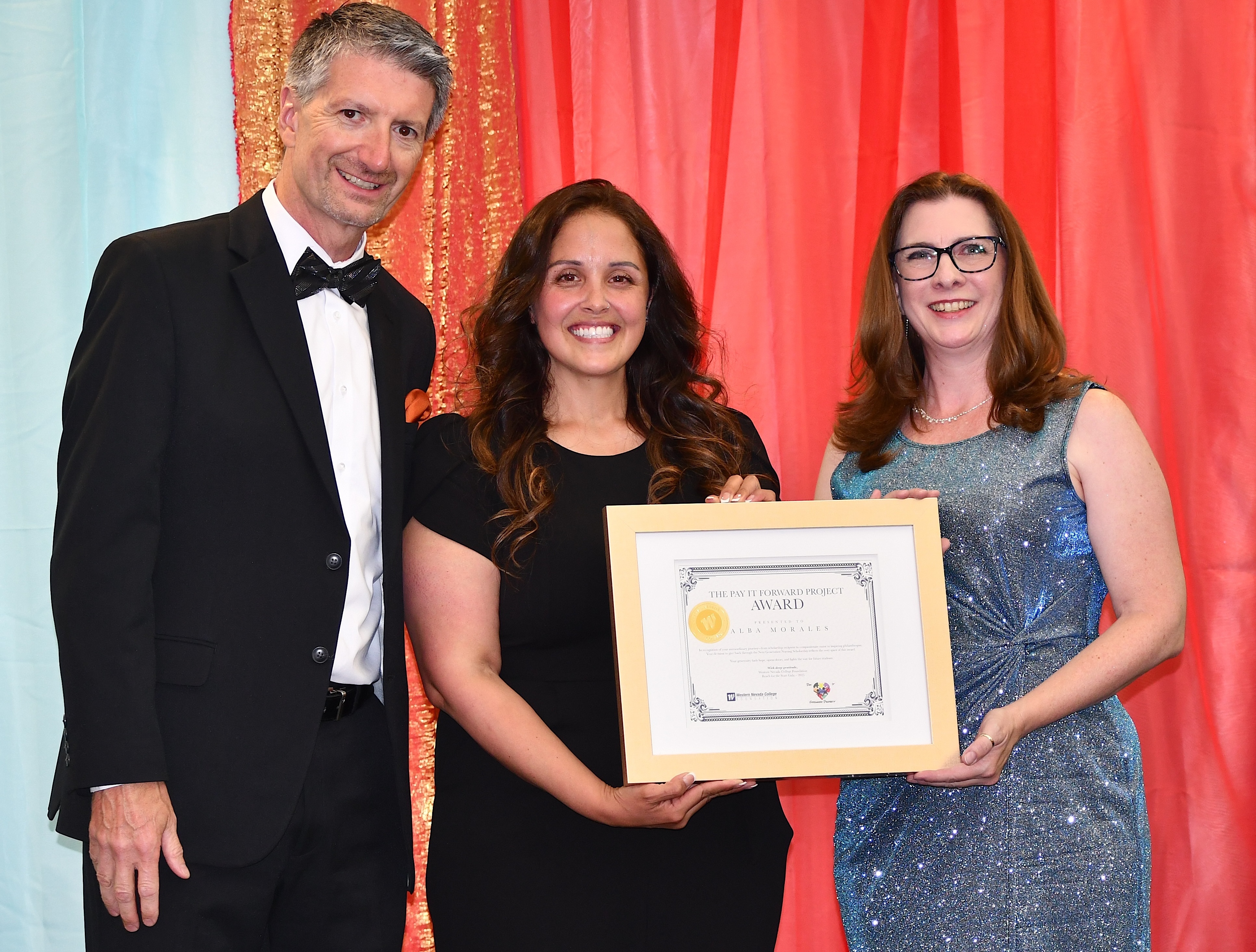 Western Nevada College nursing grad Alba Morales is flanked by WNC President Dr. J. Kyle Dalpe and WNC Foundation Board of Trustees Chair Michelle Ketten as she receives a Pay It Forward Award at the Reach for the Stars Gala on Aug. 2. 
