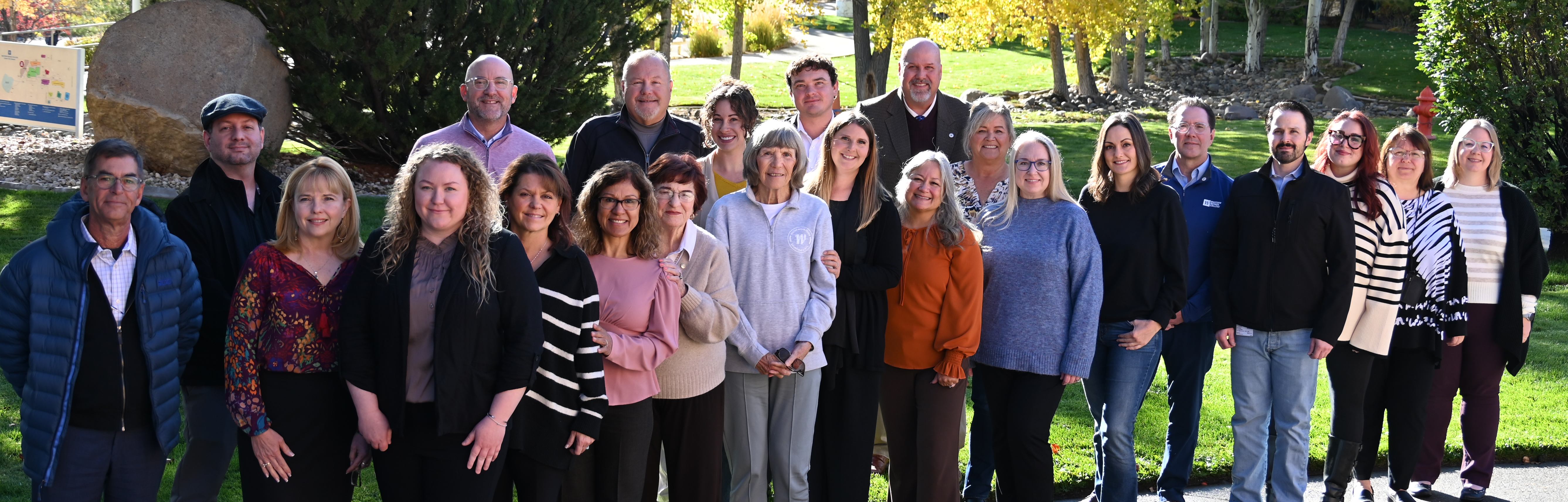 Foundation Board members gather in front of trees